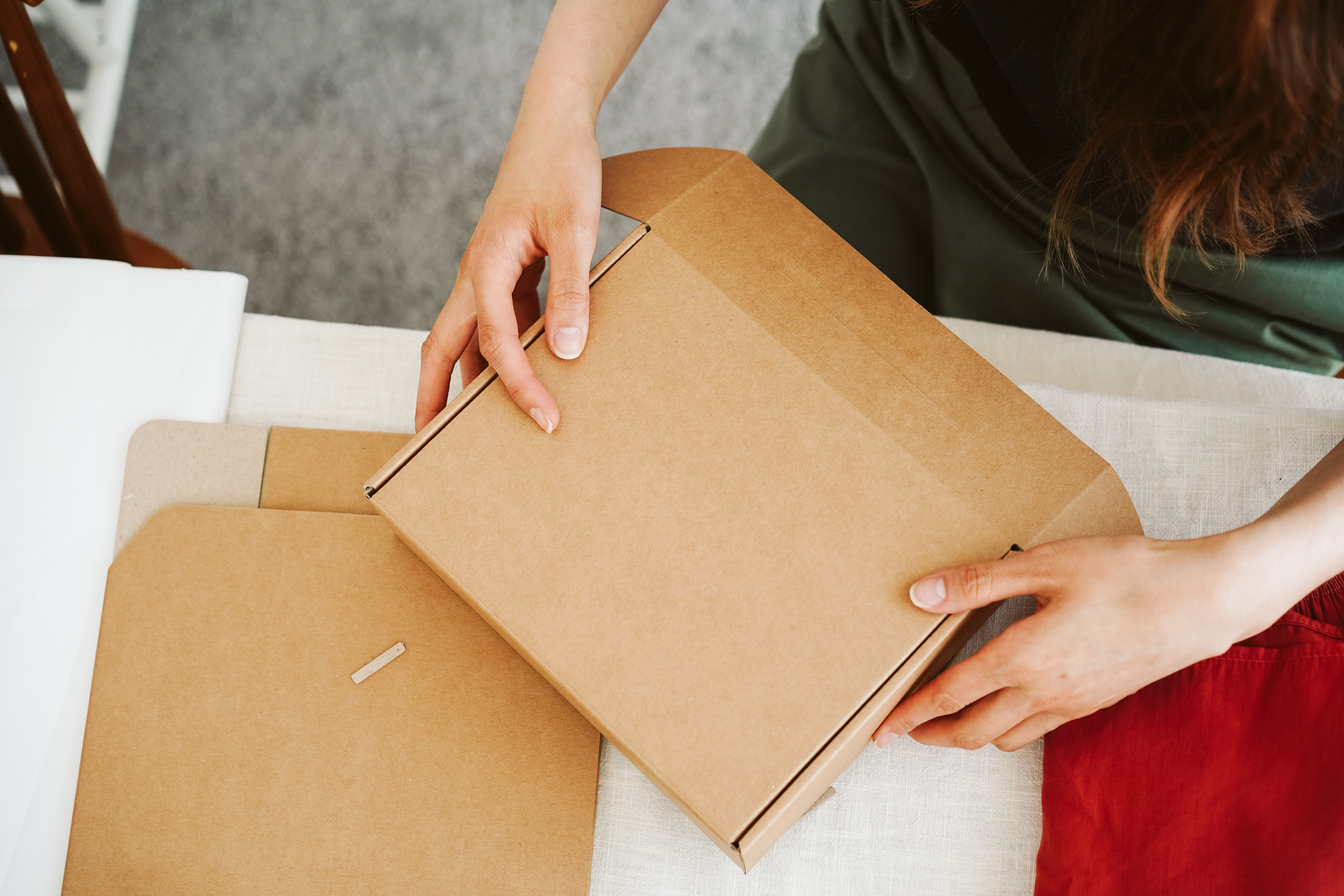 Woman Packing Orders in Cardboard Box